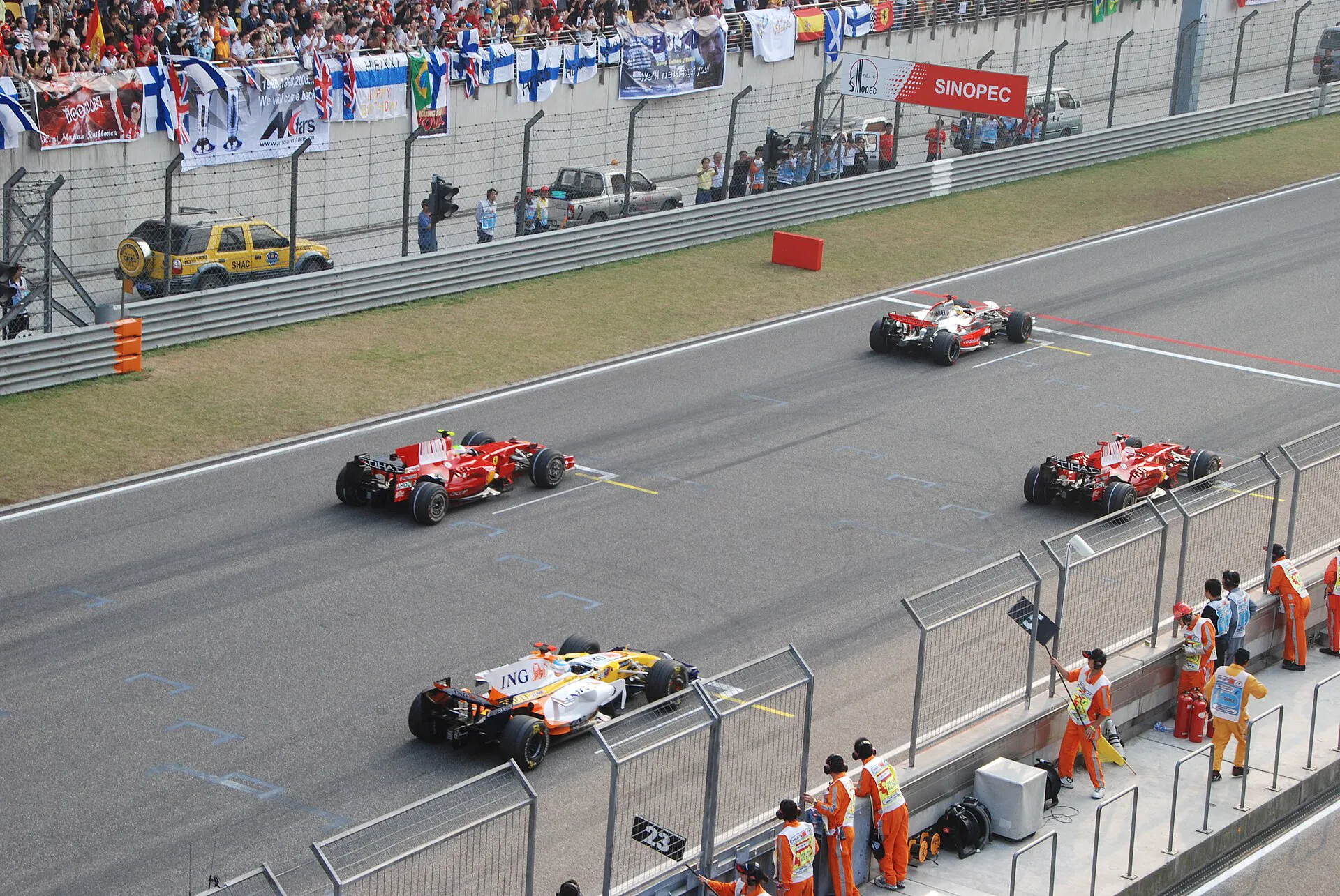 Formula 1 cars lined up on a starting grid