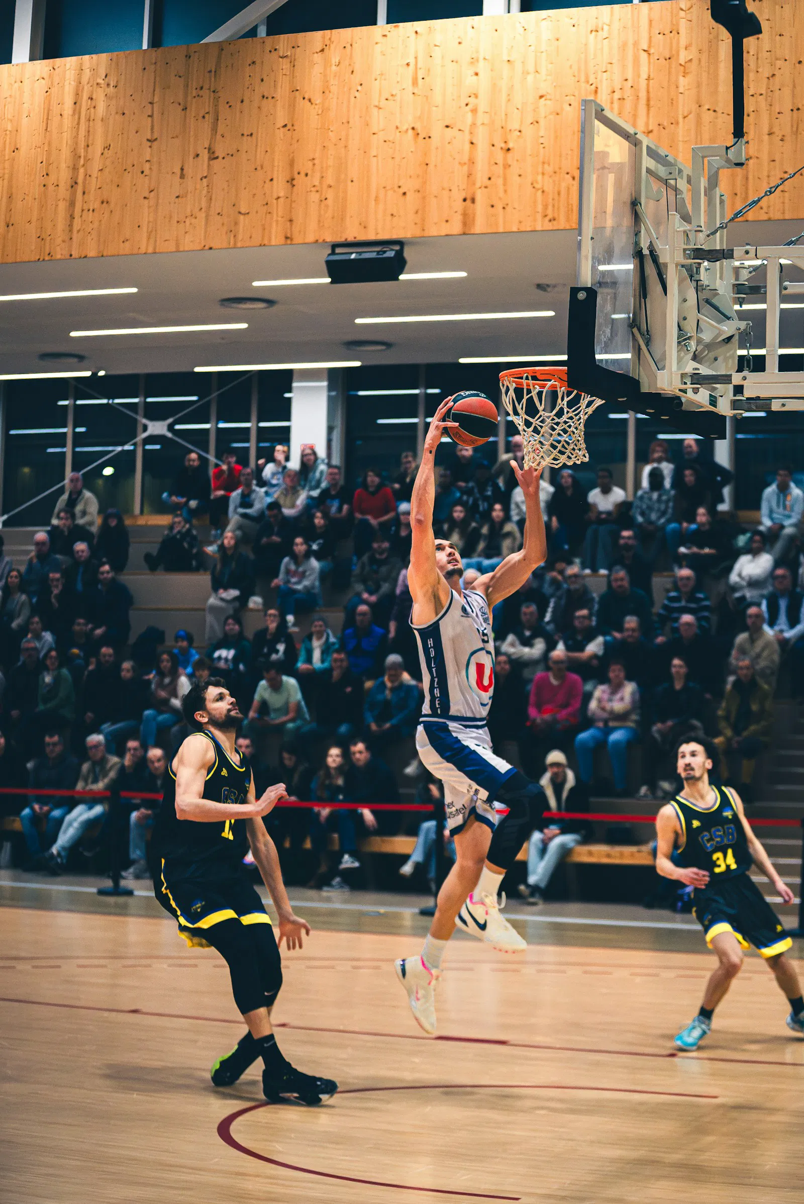 Basketball player dunking during a game